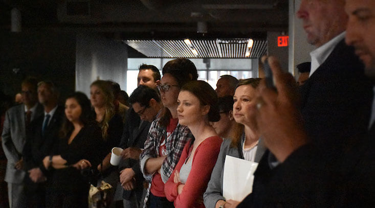 People standing at City Alive meeting