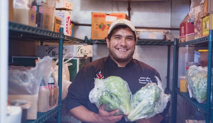 Street Food Institute Chef holding two heads of lettuce